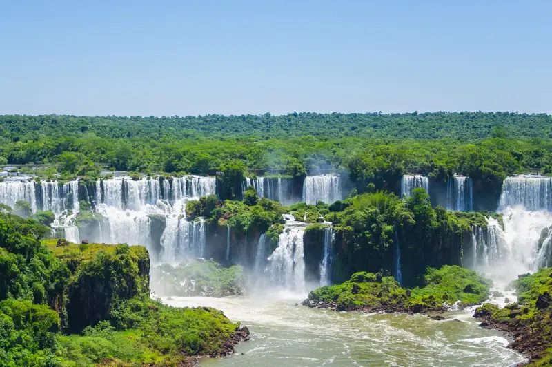 The Iguazú falls seen across the forest, several cascades at once
