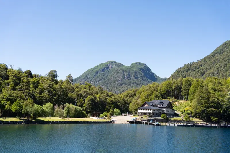 A lakeside hotel among forested hills