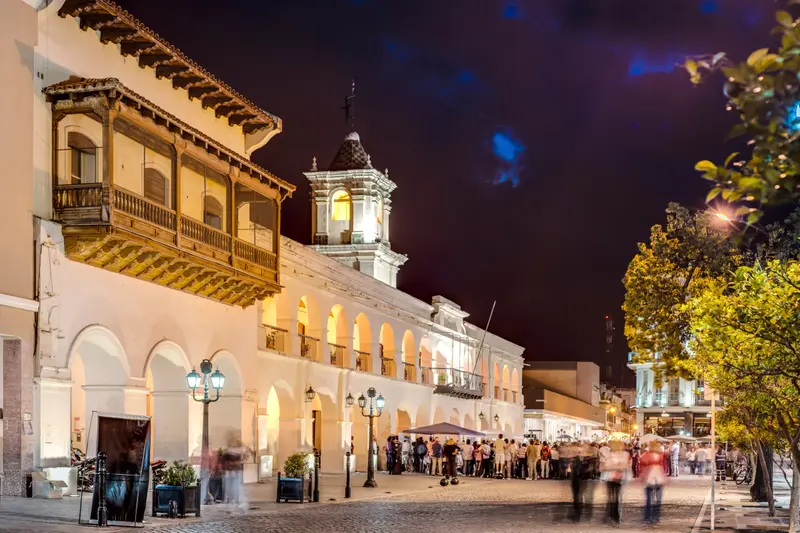 The colonial arcade of a main square, lit at night