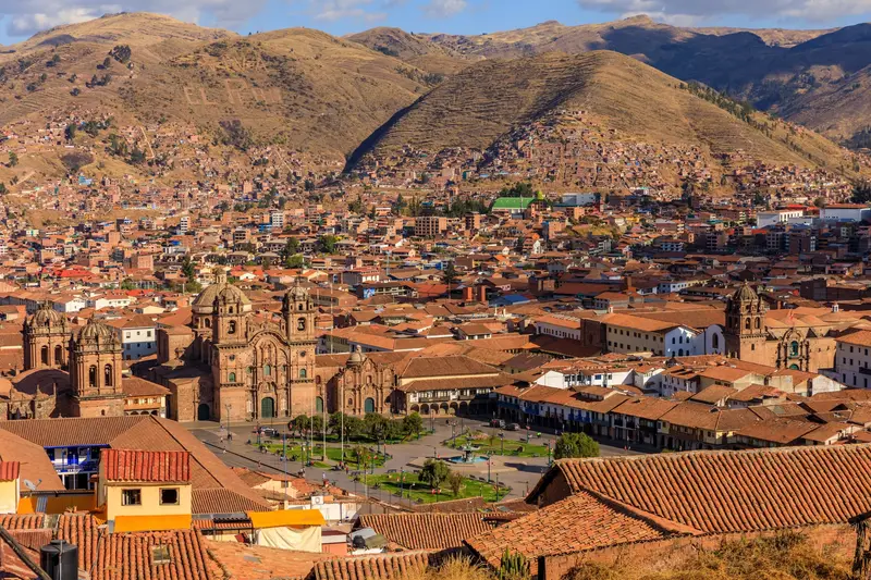 The tiled roofs of Cusco from above, with the hills around the city