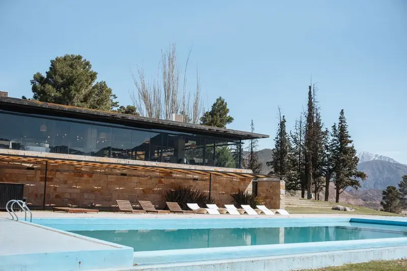 A hotel pool with the Andes behind it