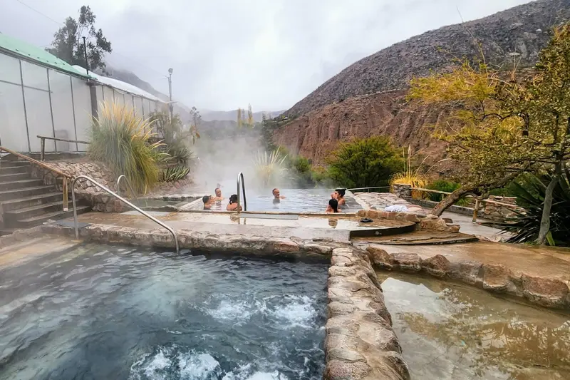 Steaming thermal pools cut into the hillside