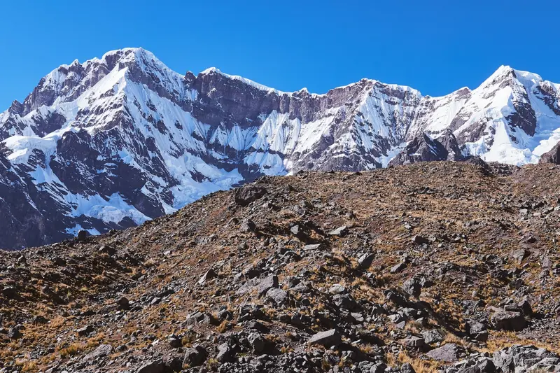 A snow-capped range above a dry ridge