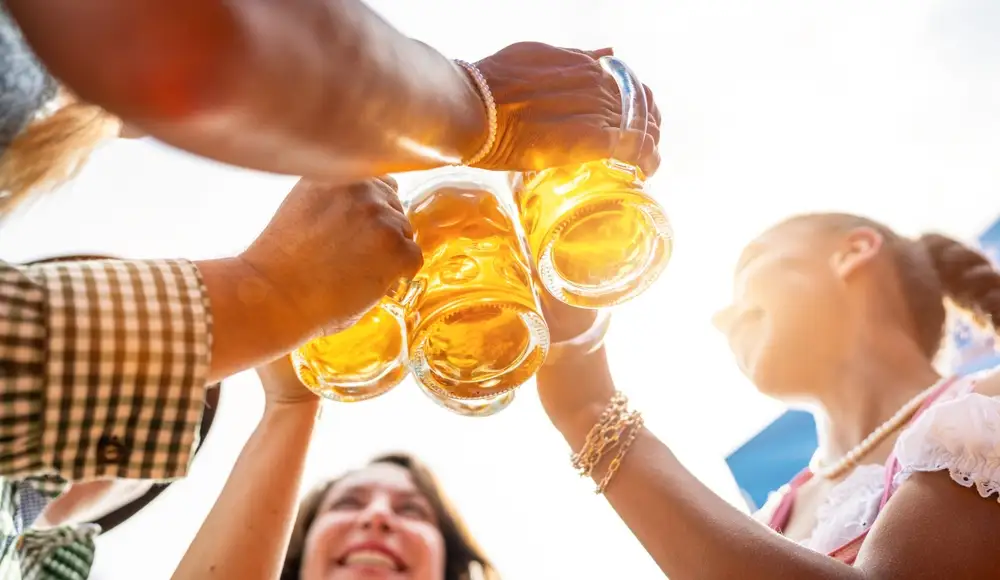 Beer glasses raised in a toast