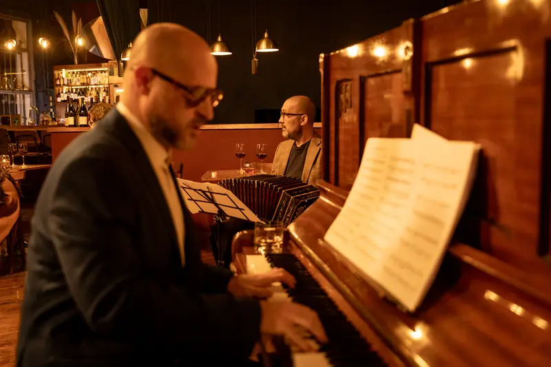 A bandoneón player reading from sheet music