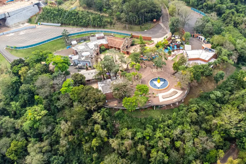 An aerial view of a park with pools and gardens in the rainforest