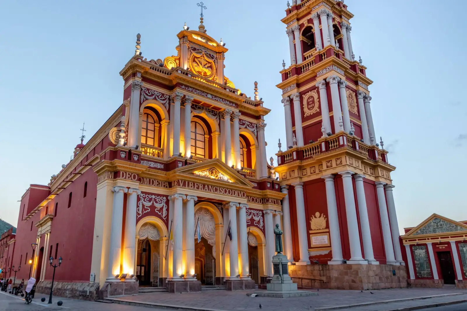 The lit facade of the Salta church at dusk