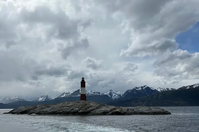 The Les Eclaireurs lighthouse on its rock under a grey sky