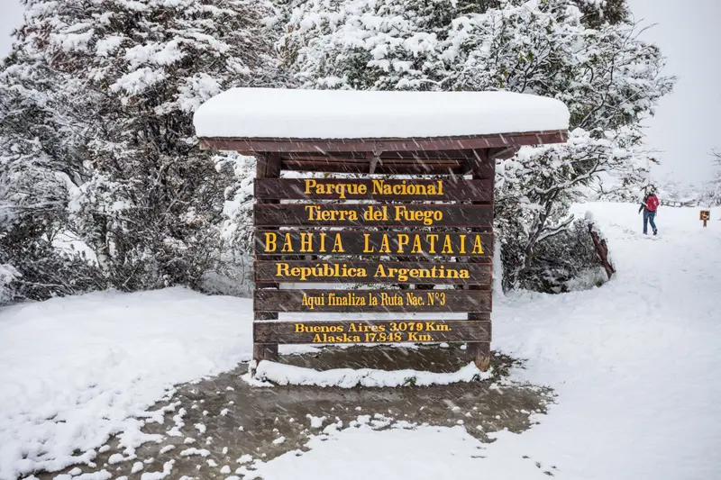 The Bahía Lapataia national park sign under snow