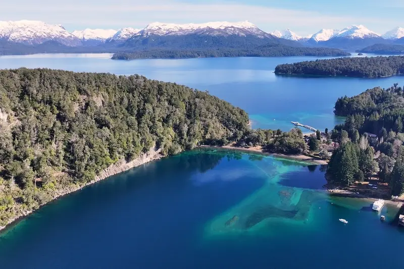 A bay from the air, with clear shallow water along the shore