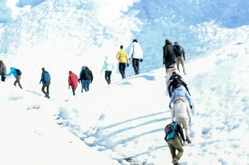 A line of walkers crossing the glacier in crampons