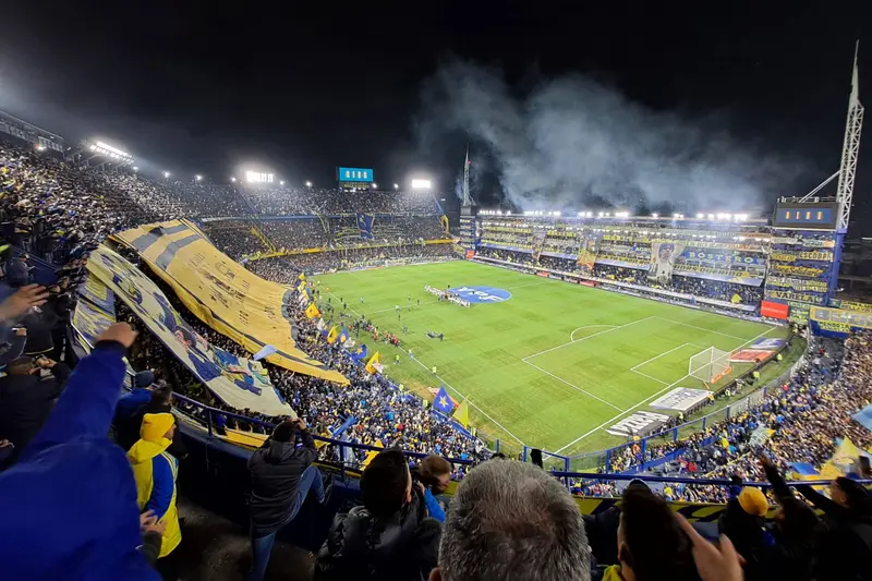 The stands at La Bombonera full of blue and yellow, with flares lit