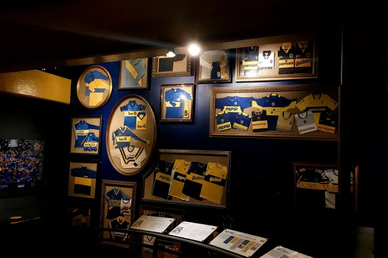 A room in the Boca museum, walls covered in pennants and shirts
