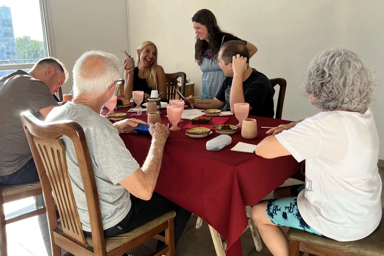 A group around a table with mates and painting materials