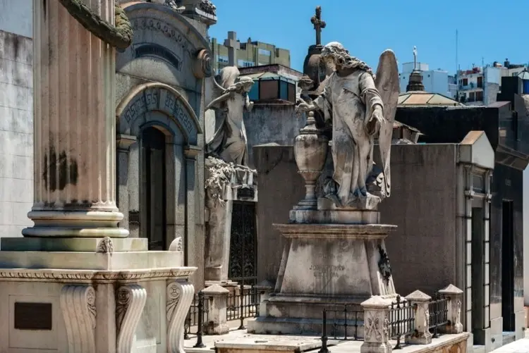 A mausoleum with stone statues in the Recoleta Cemetery