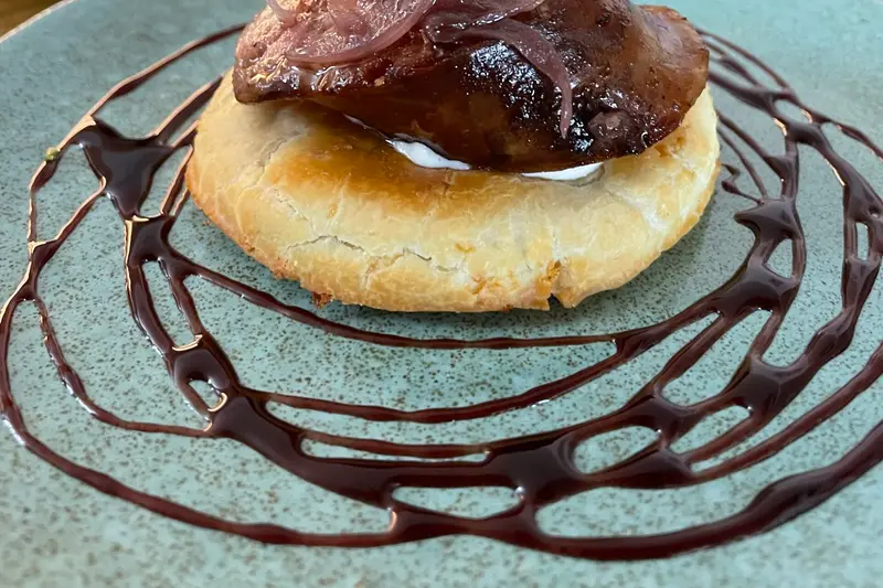 A dessert plated with a spiral of chocolate sauce