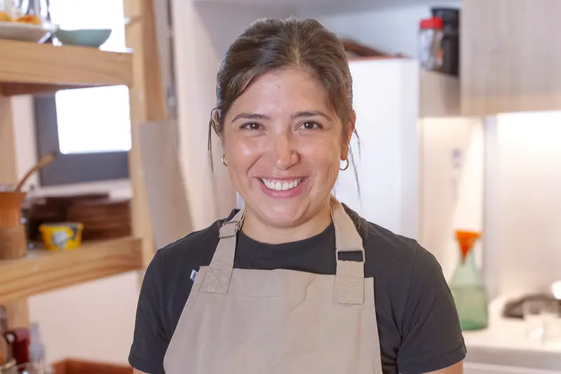 The host in an apron in the tasting room