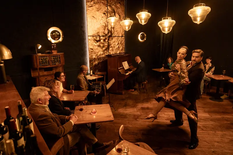 Dancers on the floor of a dimly lit tango venue