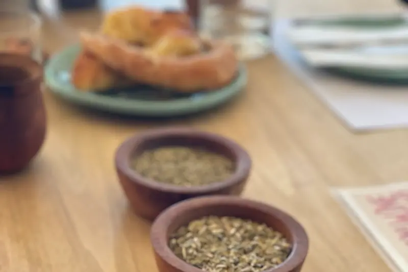 A table set with toast and small bowls of loose yerba