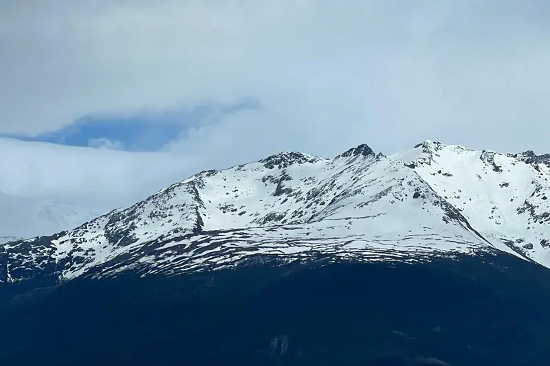 A snow-covered peak rising above the water
