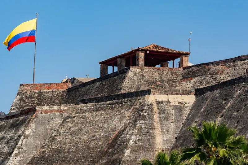 The stone fortress with the Colombian flag over it