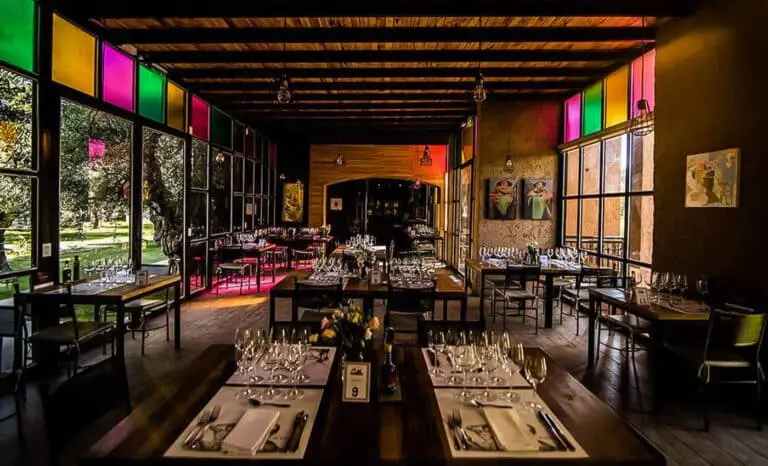 A winery dining room with panels of stained glass along one wall