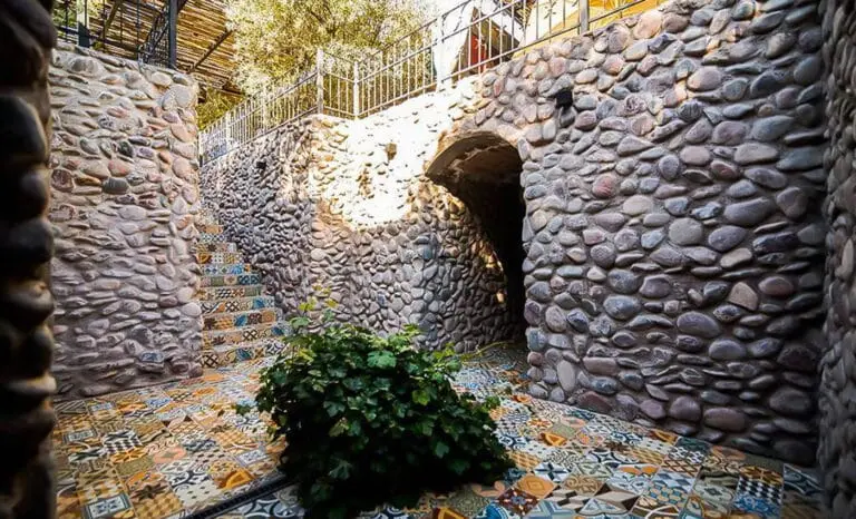 A stone tunnel with a tiled floor at the winery