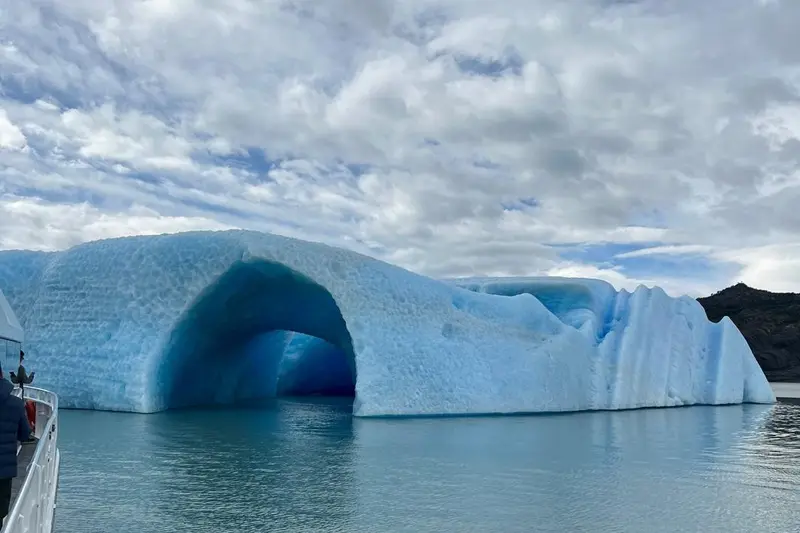 An arch of blue ice floating on the lake