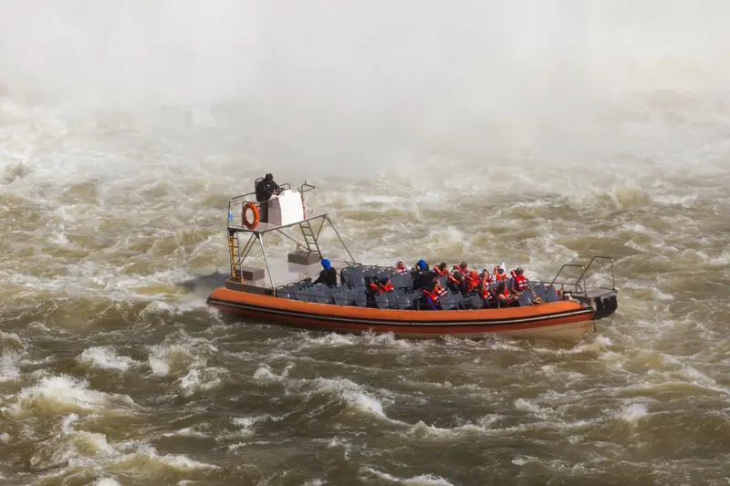 The speedboat in white water below the falls