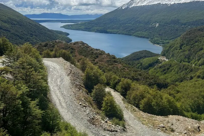 A gravel road running above the lake through the forest