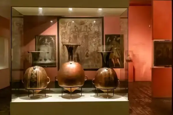Gold and metal vessels in a museum case