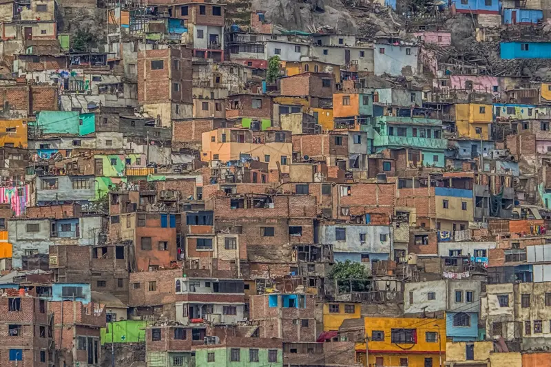 A hillside covered in painted houses stacked on each other