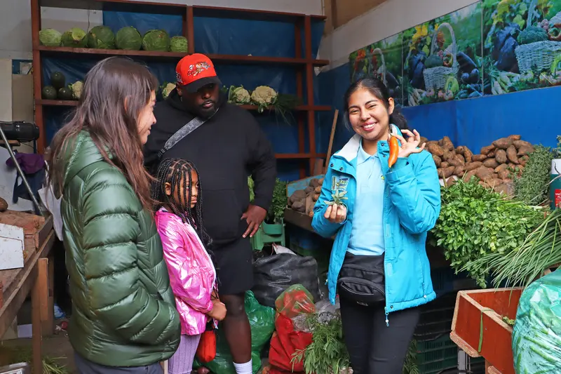 Local grocery store and lady showing a Peruvian chilly