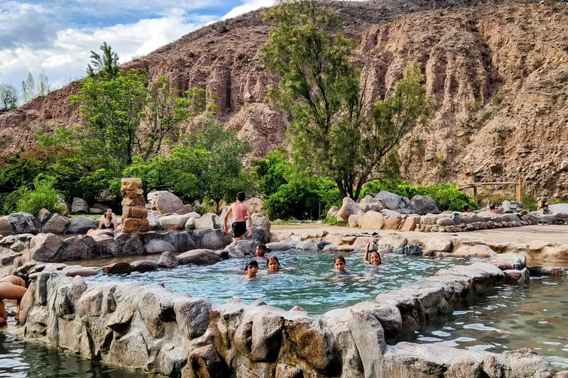 Thermal pools among the rocks, with bathers in them