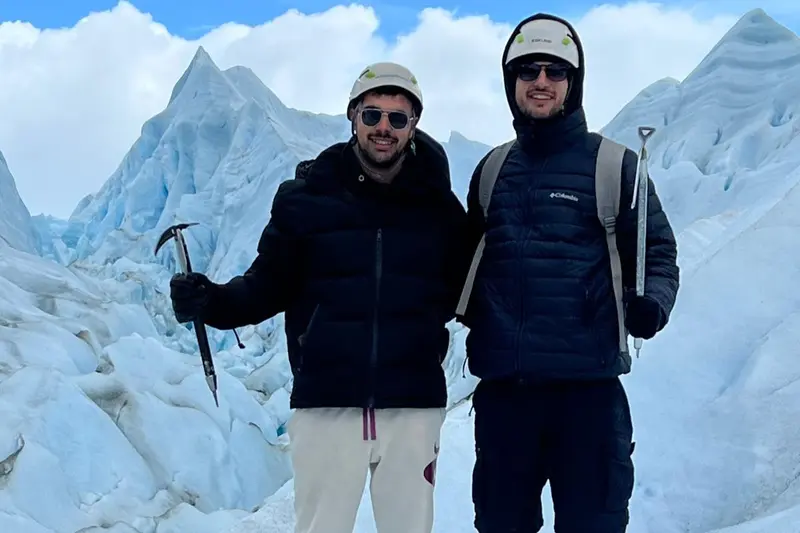 Two people with ice axes standing on the glacier