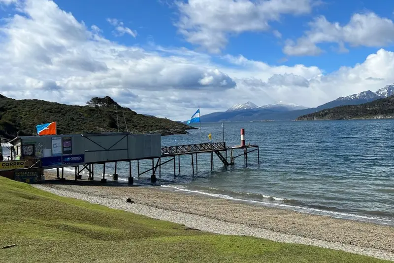 A jetty on the lake with flags along it