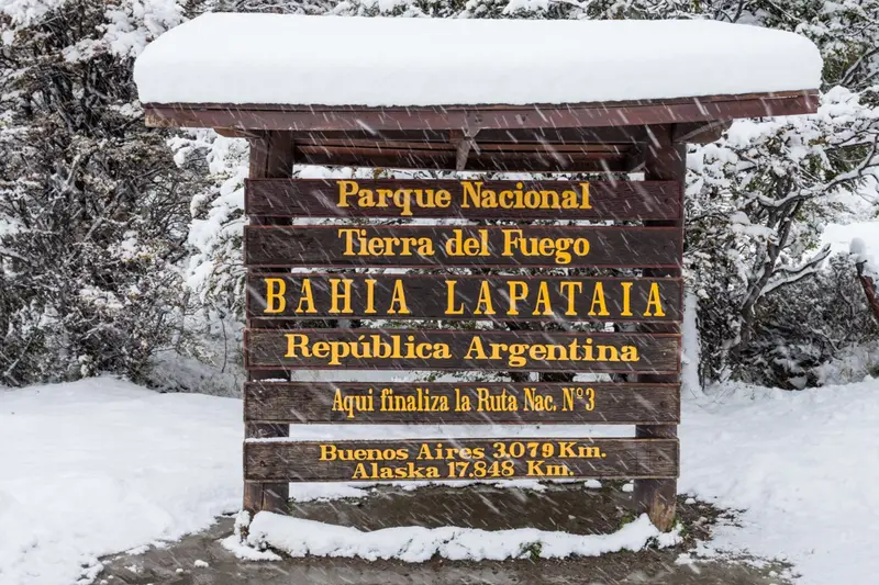 The Bahía Lapataia national park sign under snow