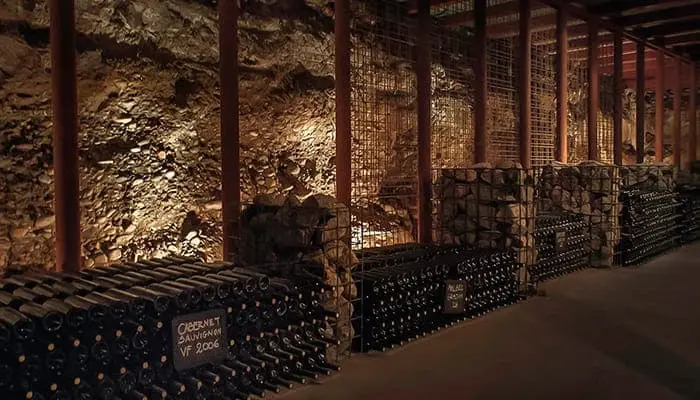 A cellar with racks of bottles along the walls