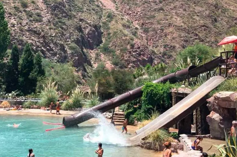 A water slide running down into the pool