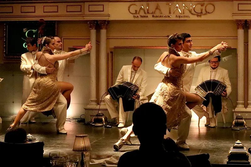 Dancers and musicians on stage at the Gala Tango venue
