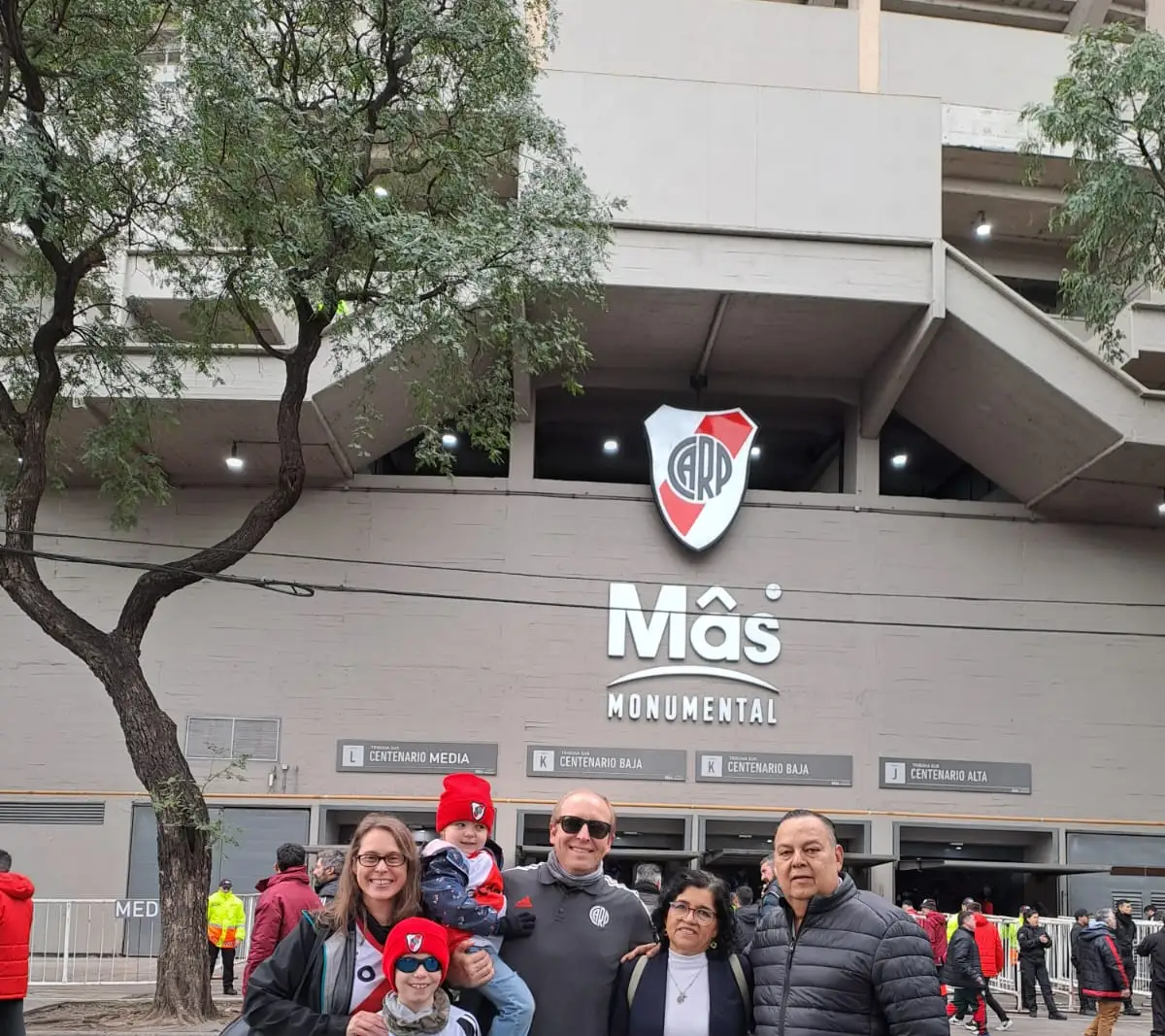 The outside of El Monumental, with the club badge on the wall