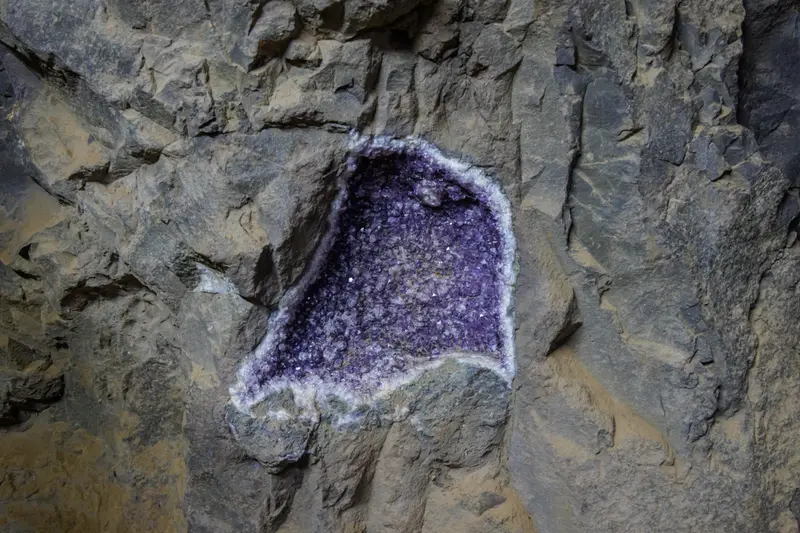 A seam of purple amethyst in the rock face