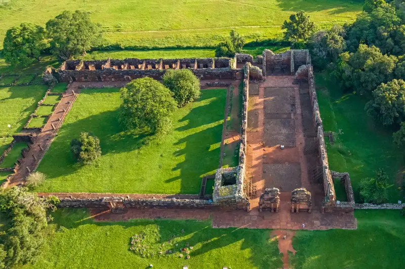The San Ignacio mission ruins from above, walls standing on the grass