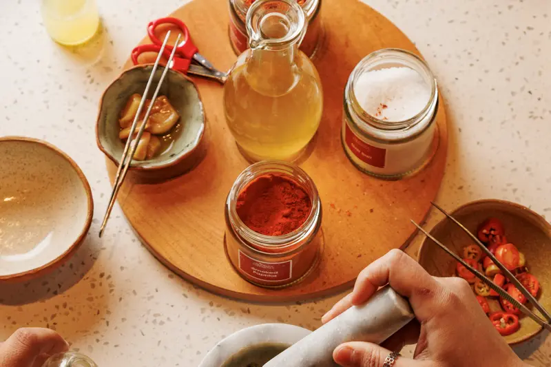 A board of jars and dips with a mortar, seen from above