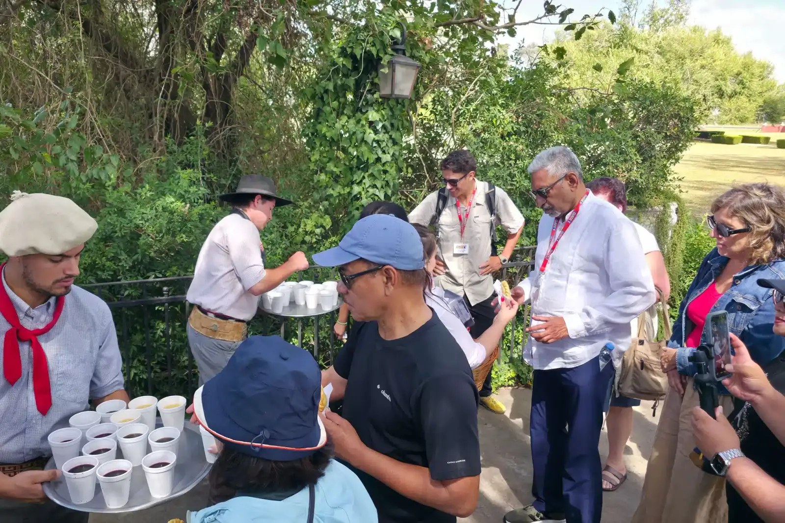 A host handing out drinks to the group on arrival