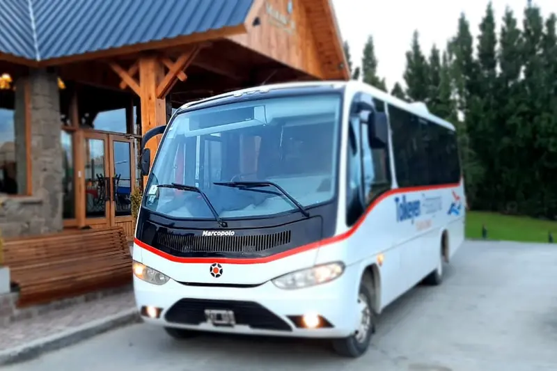 A coach parked outside a lodge