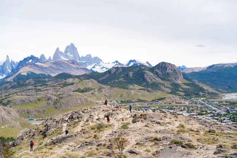 Walkers on the ridge above the town, with Fitz Roy behind