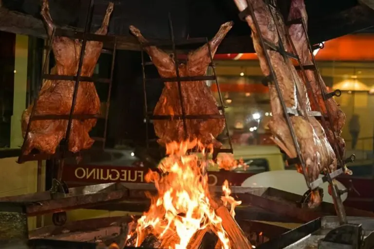 Lamb on crosses roasting beside an open fire