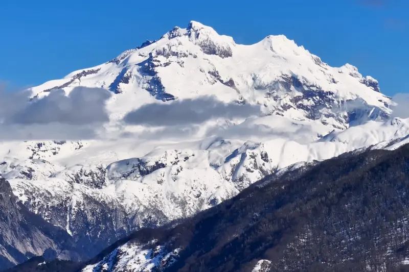 The snow-covered summit of Tronador against the sky