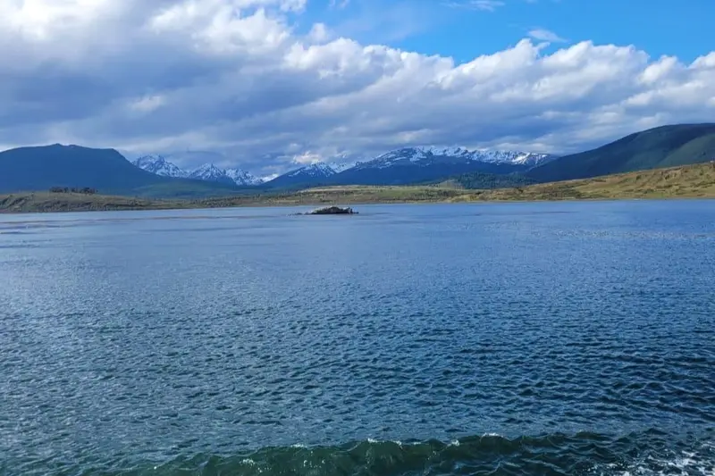 Lake Traful under cloud, with snow peaks along the far shore